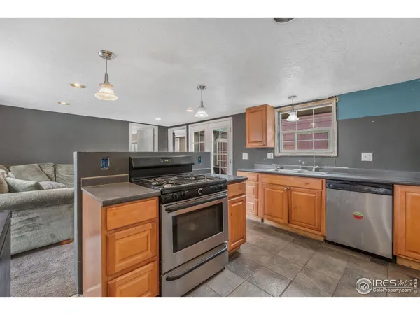 a kitchen with stainless steel appliances granite countertop a sink and cabinets