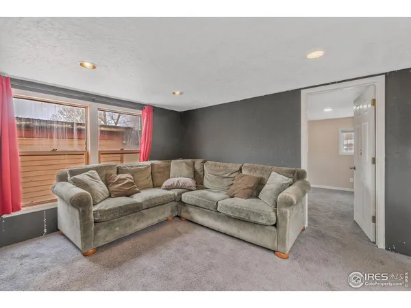 a view of an empty room with a kitchen