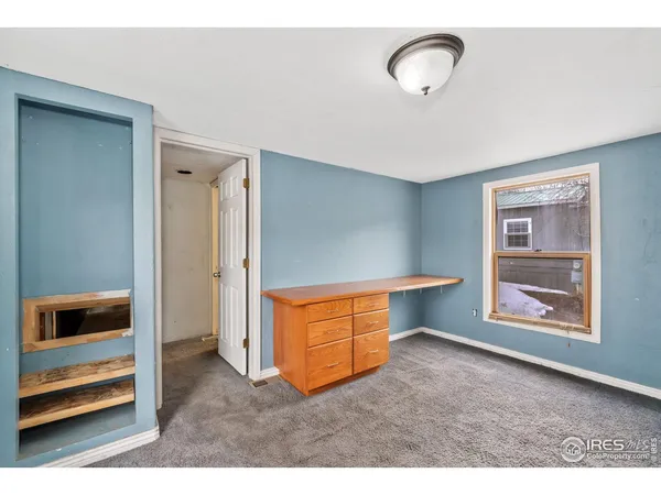 view of an empty room with a window and wooden floor