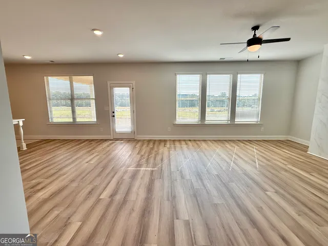 a view of a kitchen center island sink and cabinets