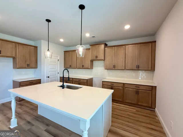 a view of a kitchen with a sink and chandelier