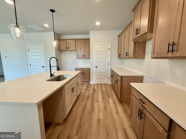 a view of a hallway with wooden floor and entryway