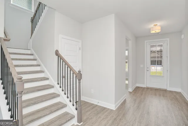 a large white kitchen with a sink and dishwasher stove