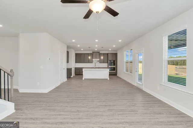 a spacious bathroom with a granite countertop sink a mirror and a bathtub