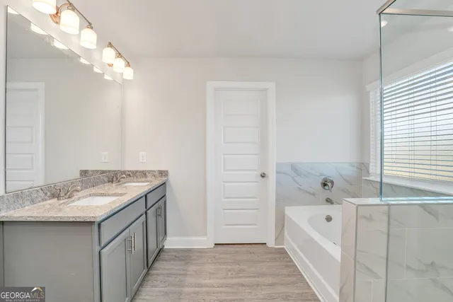 a bathroom with a bathtub and a shower