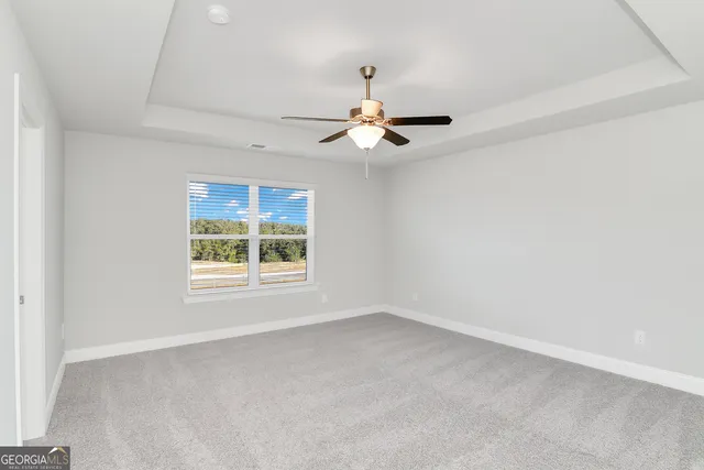 a view of an empty room with a ceiling fan
