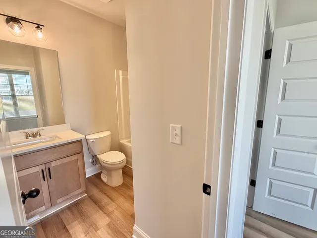 a bathroom with a sink mirror and toilet