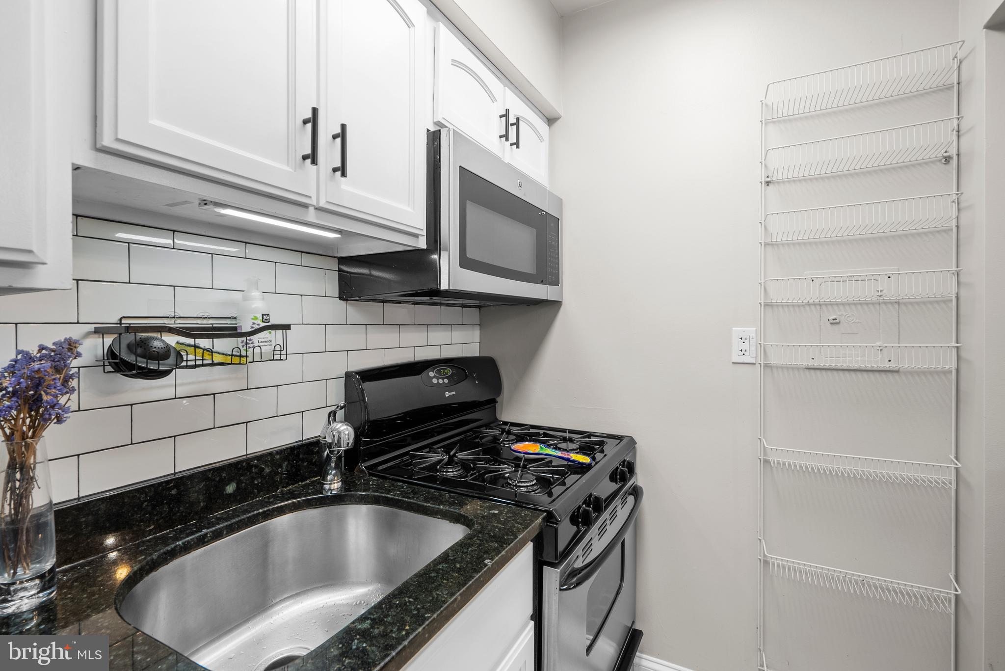 718 Park Road Northwest, Unit 1 Washington, DC 20010 - Photo 19 of 28 a kitchen with a sink and cabinets