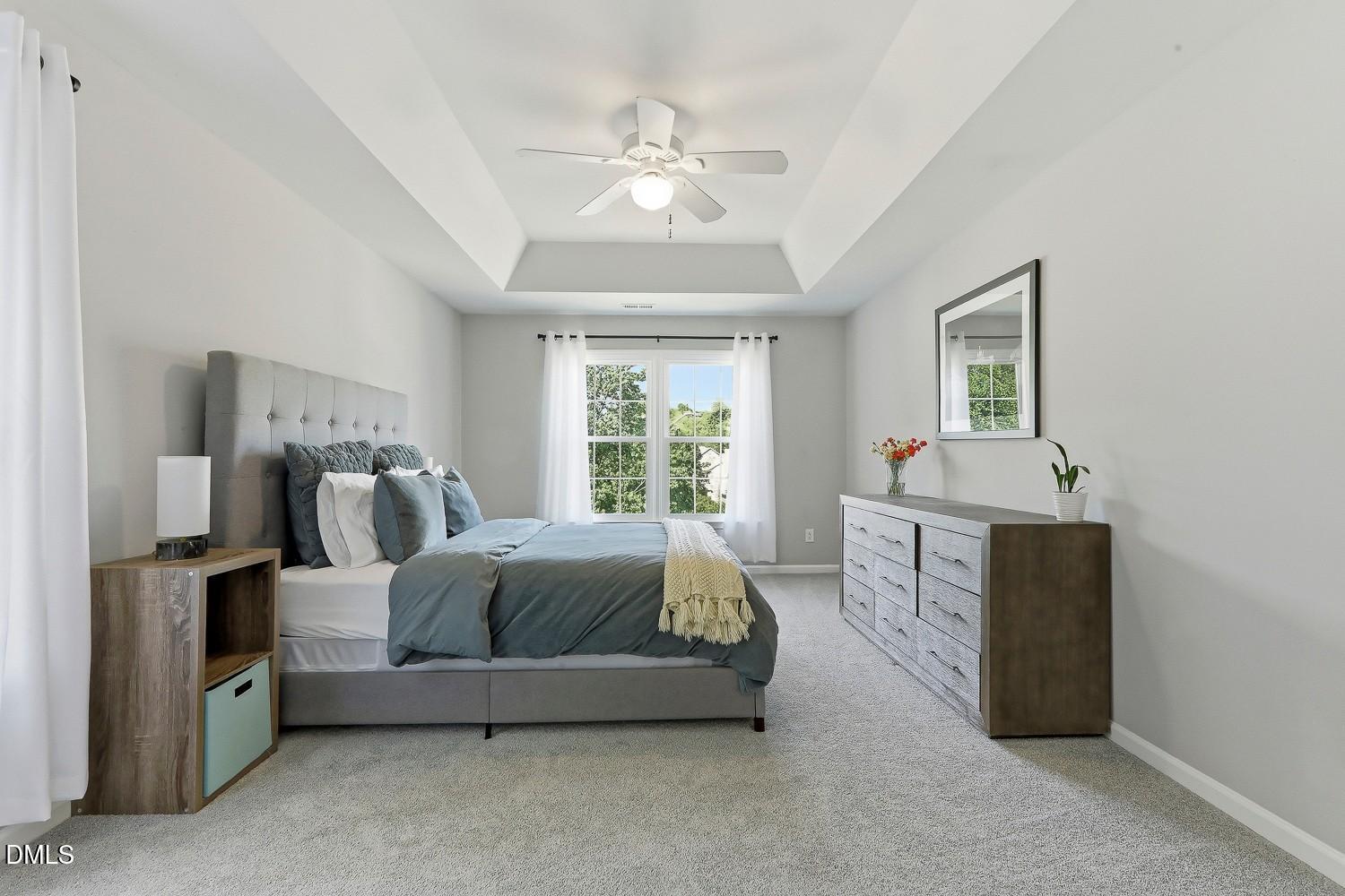 4001 Batiste Road Raleigh, NC 27613 - Photo 28 of 63 a bed room with a bed and a chandelier
