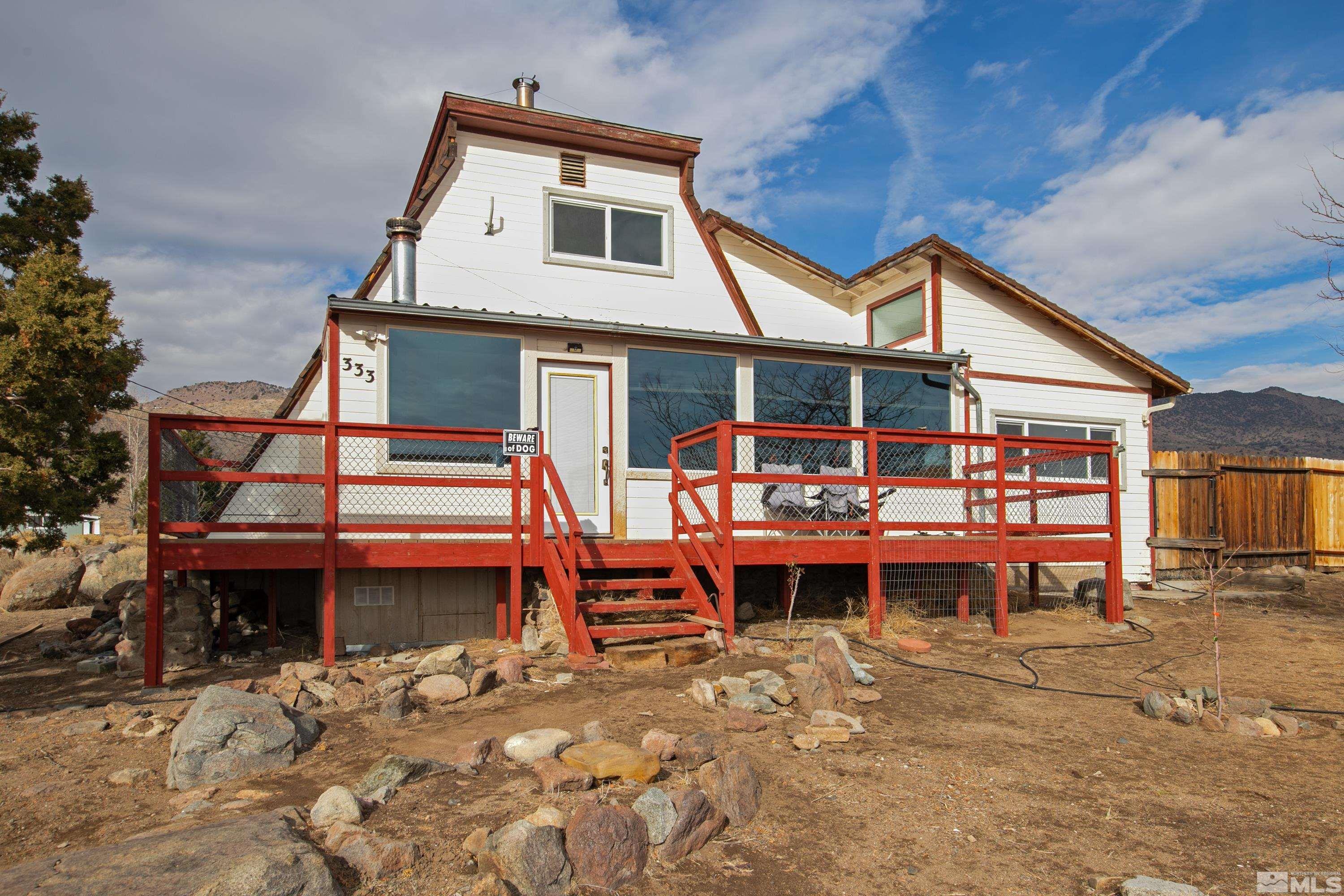 333 Territory Road Dayton, NV 89403 - Photo 1 of 38 a view of a house with a wooden roof and a bench