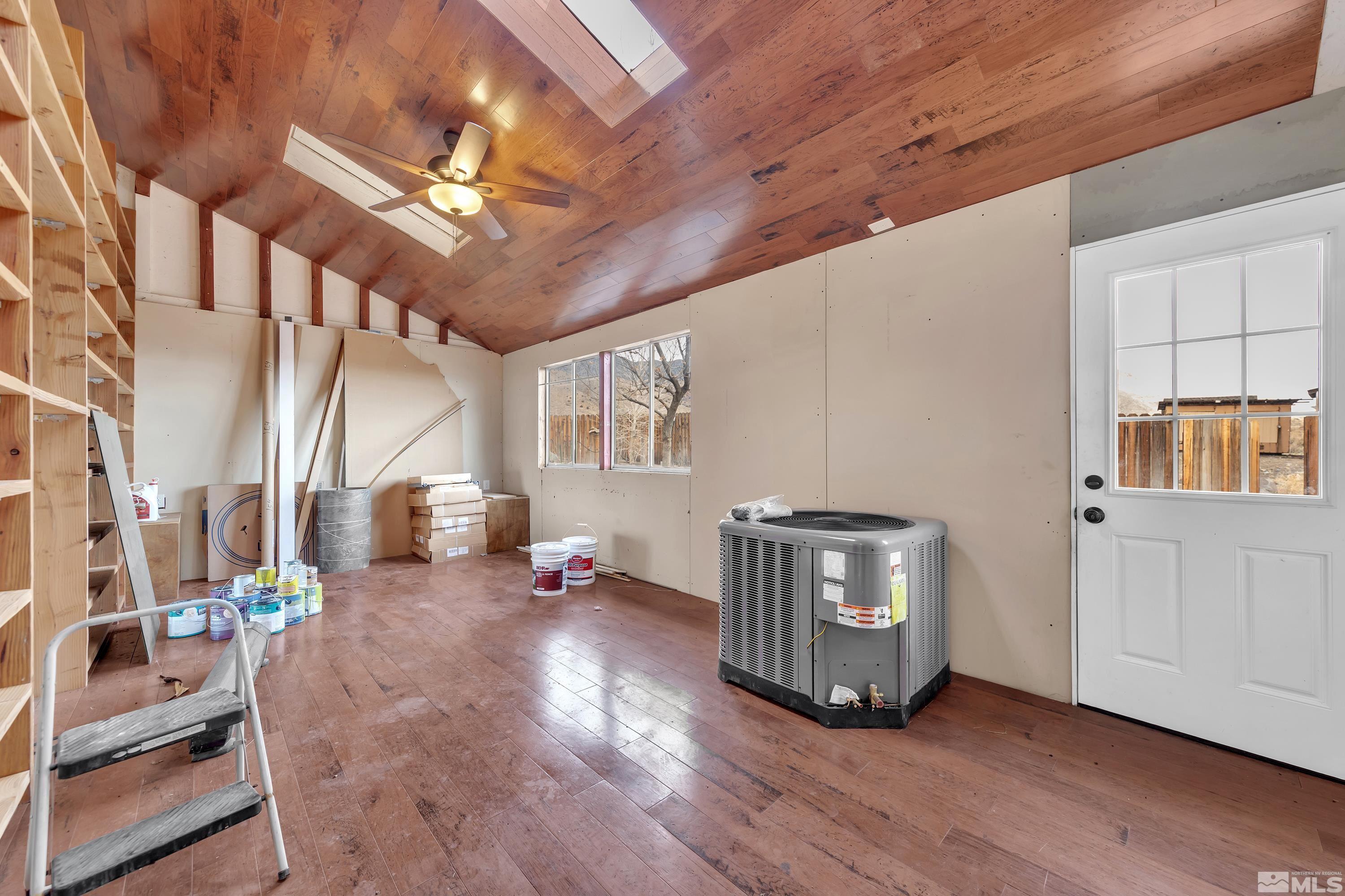 333 Territory Road Dayton, NV 89403 - Photo 13 of 38 a view of an empty room with wooden floor and a window