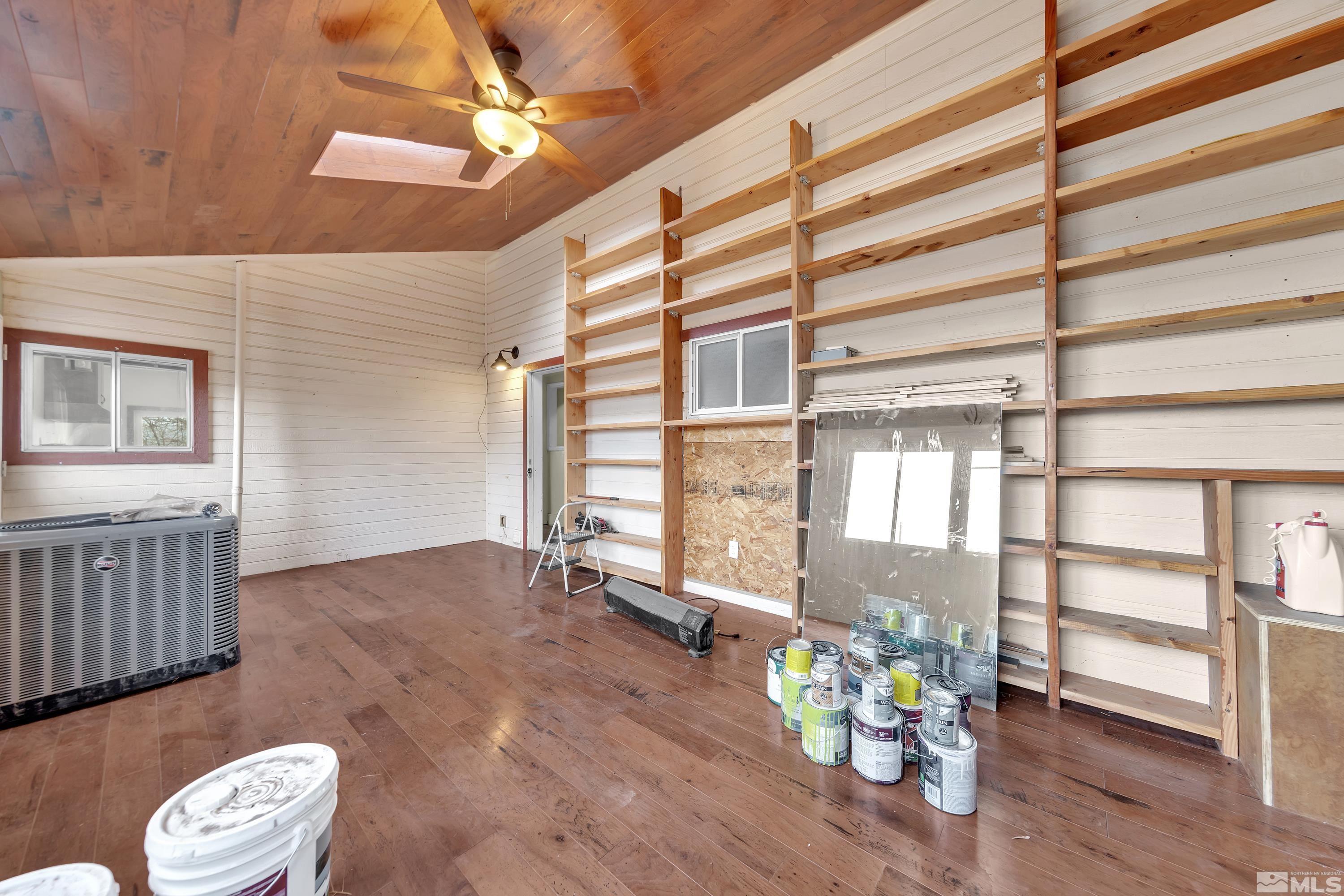 333 Territory Road Dayton, NV 89403 - Photo 14 of 38 a view of an empty room with a window and wooden floor