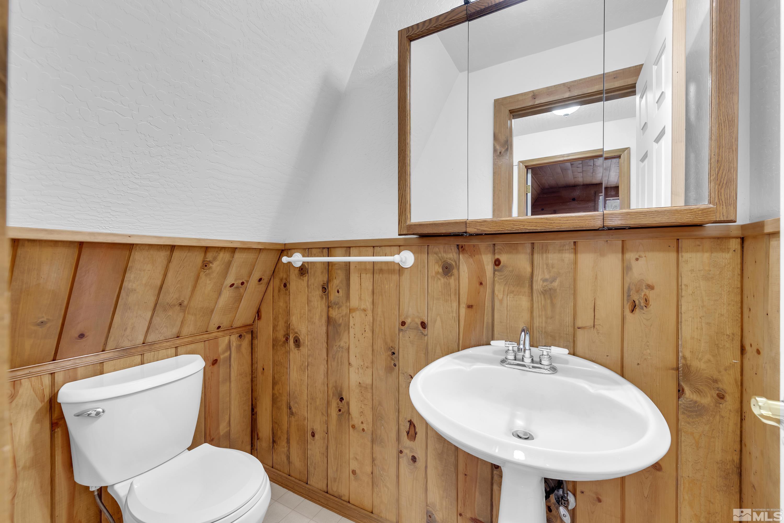 333 Territory Road Dayton, NV 89403 - Photo 19 of 38 a bathroom with a toilet sink and mirror