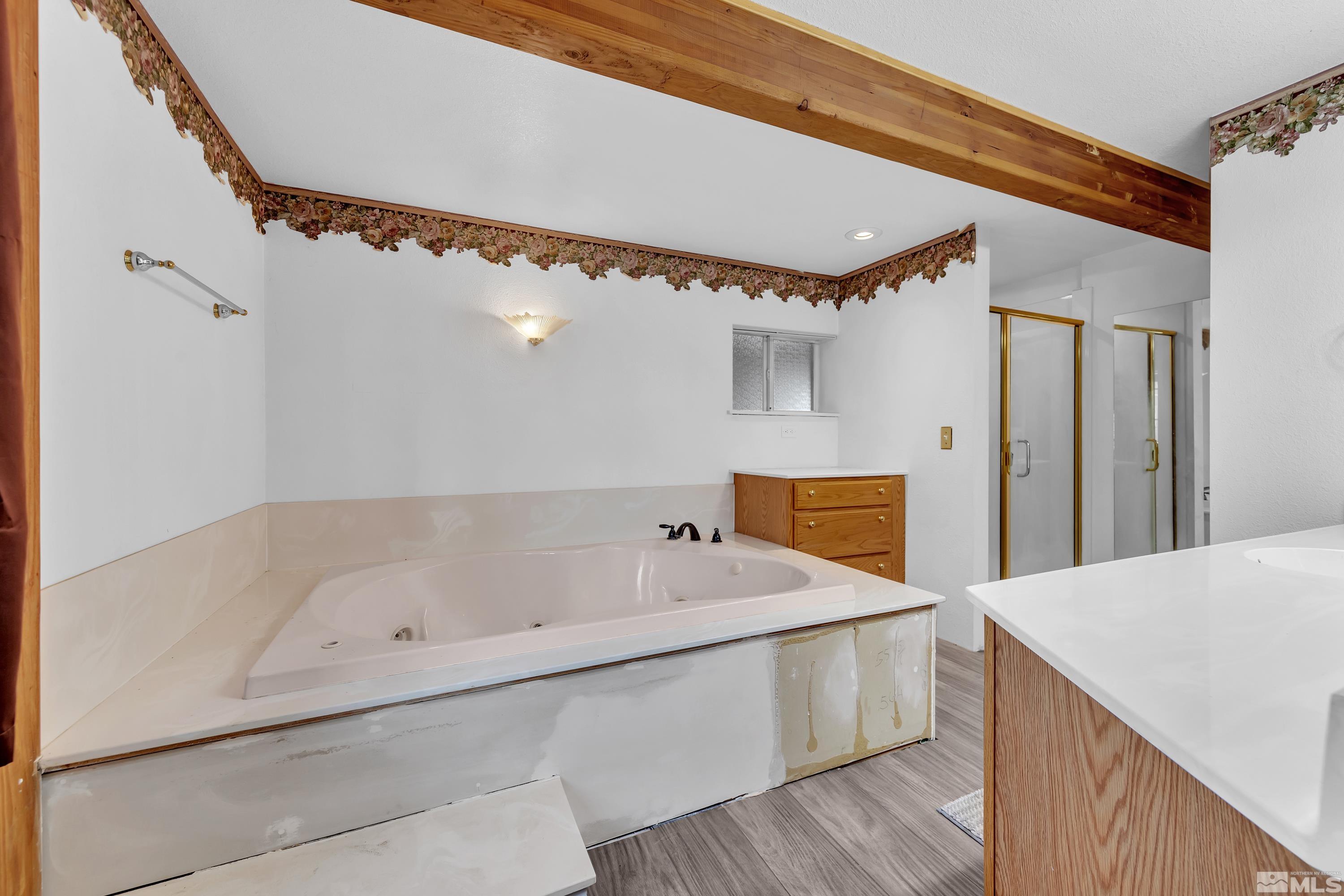 333 Territory Road Dayton, NV 89403 - Photo 20 of 38 a bathroom with a tub a mirror and a shower