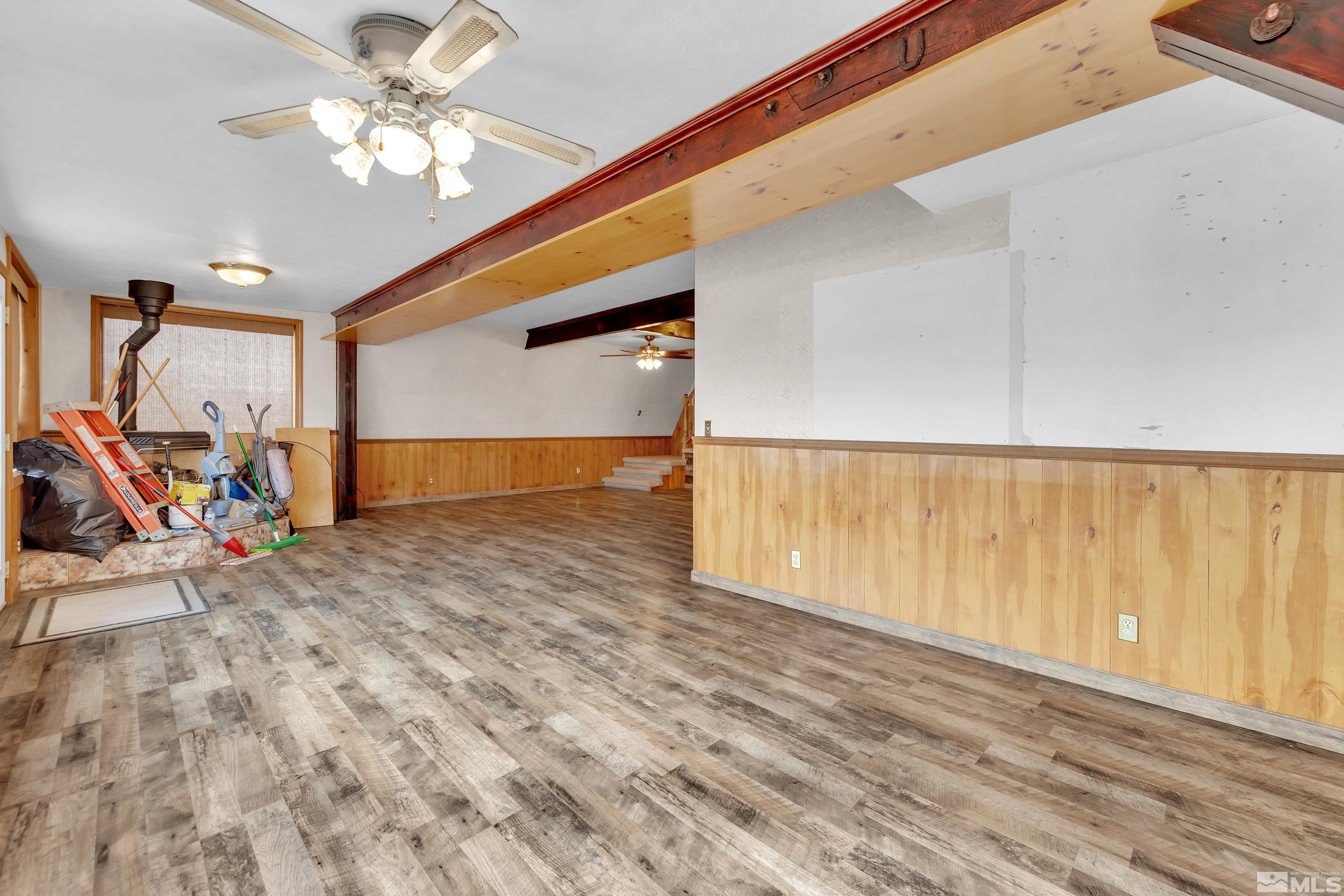 333 Territory Road Dayton, NV 89403 - Photo 4 of 38 a view of a room with wooden floor and ceiling fan