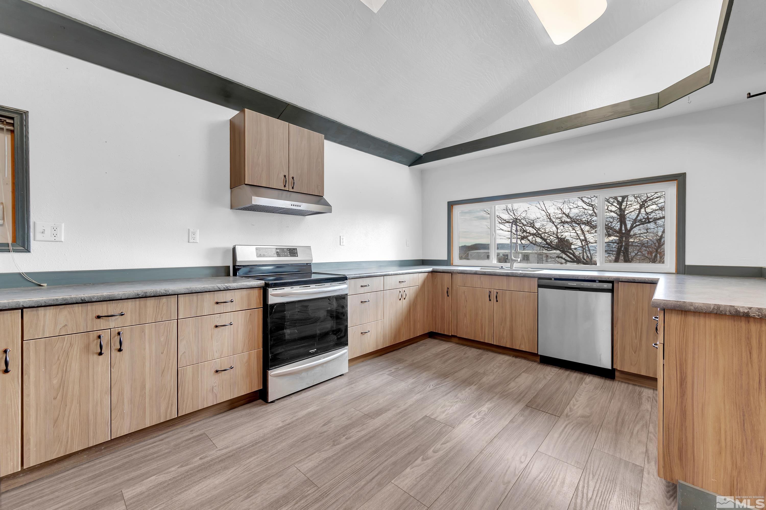 333 Territory Road Dayton, NV 89403 - Photo 7 of 38 a kitchen with stainless steel appliances a white stove top oven sink and cabinets