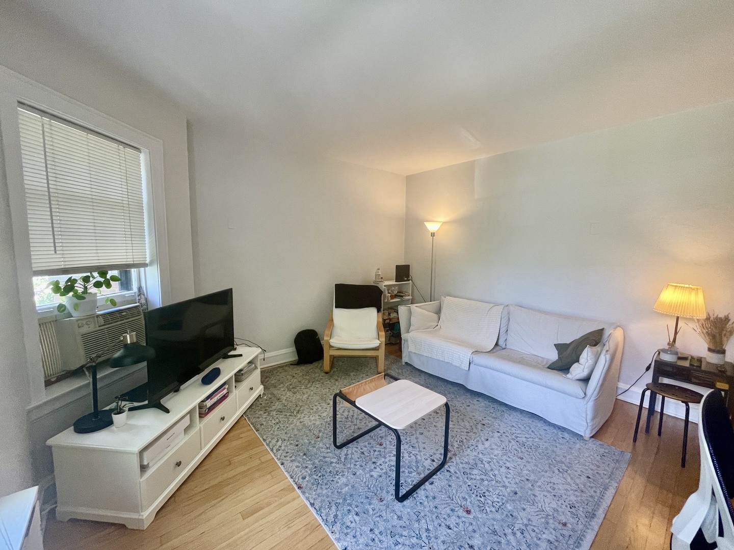 1112 Grove Street, Unit 1B Evanston, IL 60201 - Photo 2 of 14 a living room with furniture and a flat screen tv