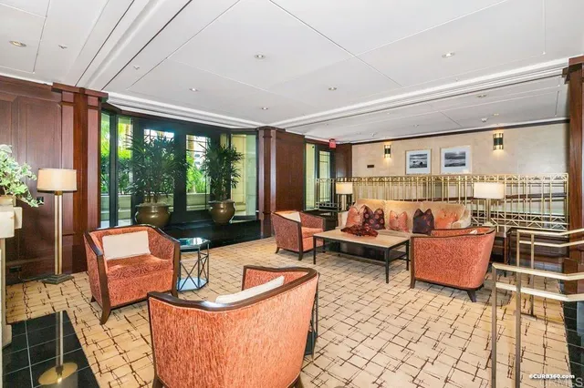 a living room with furniture and large windows
