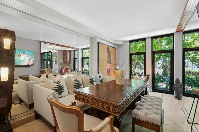 a view of a dining room with furniture large windows and wooden floor