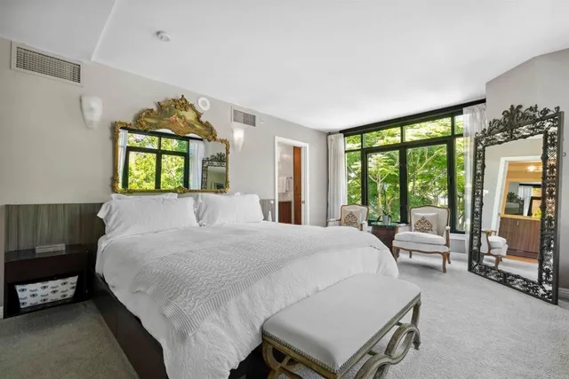 a large bedroom with a bed and a large window