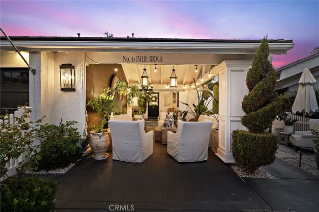 a view of a patio with couches and a potted plant on the road