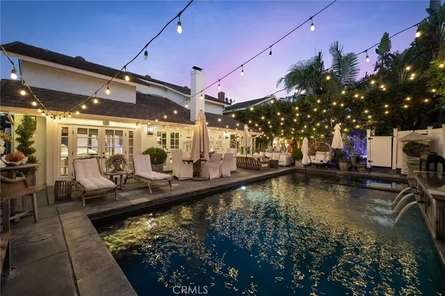 a view of a swimming pool with outdoor seating