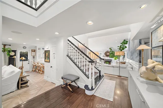 a living room with furniture fireplace and a large window