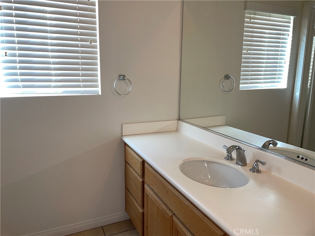 12661 Luna Road Victorville, CA 92392 - Photo 13 of 20 a bathroom with a sink and a mirror