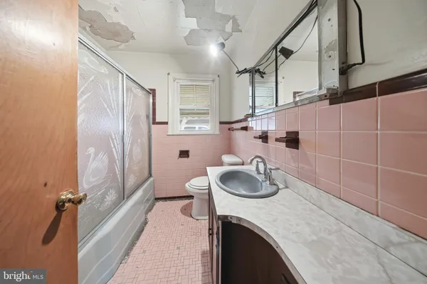 a bathroom with a sink a toilet and a shower