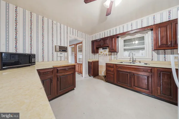 a large kitchen with stainless steel appliances granite countertop a sink dishwasher stove and cabinets