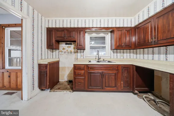 a kitchen with stainless steel appliances granite countertop a sink dishwasher stove and cabinets