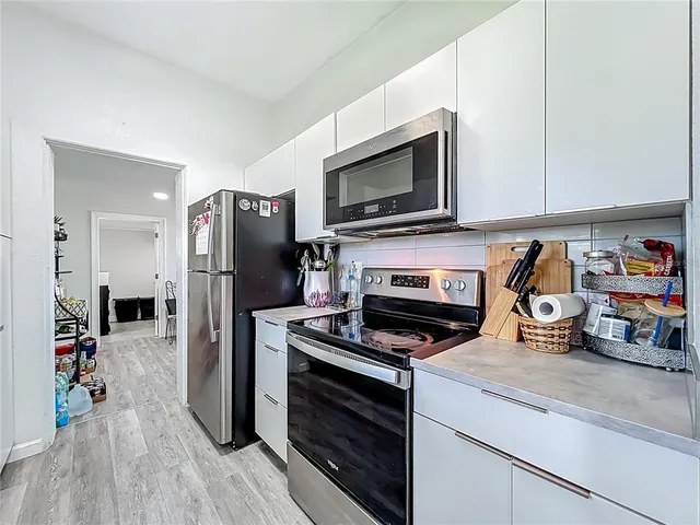 a kitchen with a stove microwave and refrigerator