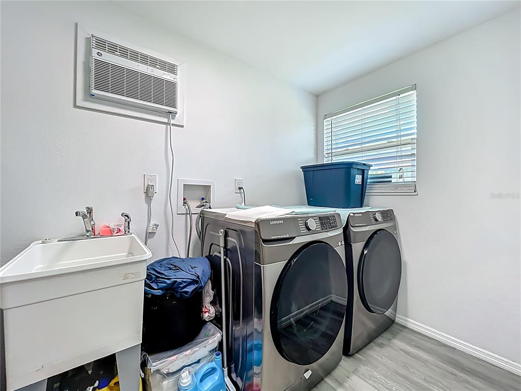7033 Lakner Way Orlando, FL 32822 - Photo 16 of 31 a utility room with dryer and washer