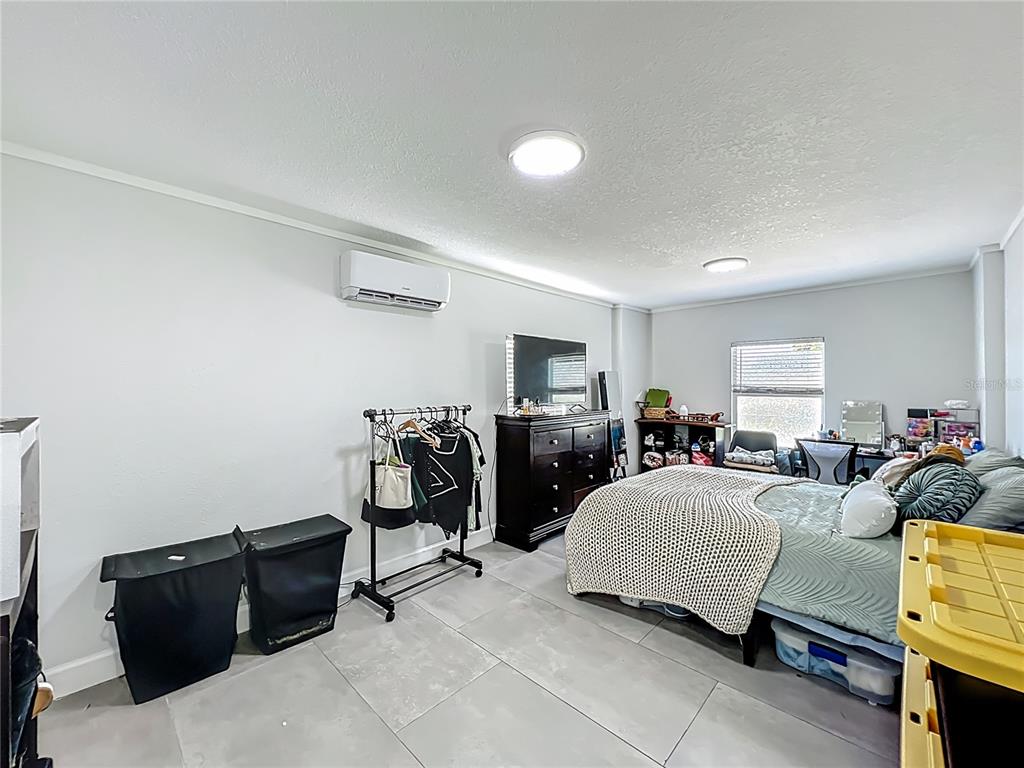 7033 Lakner Way Orlando, FL 32822 - Photo 18 of 31 a bedroom with furniture and a flat screen tv