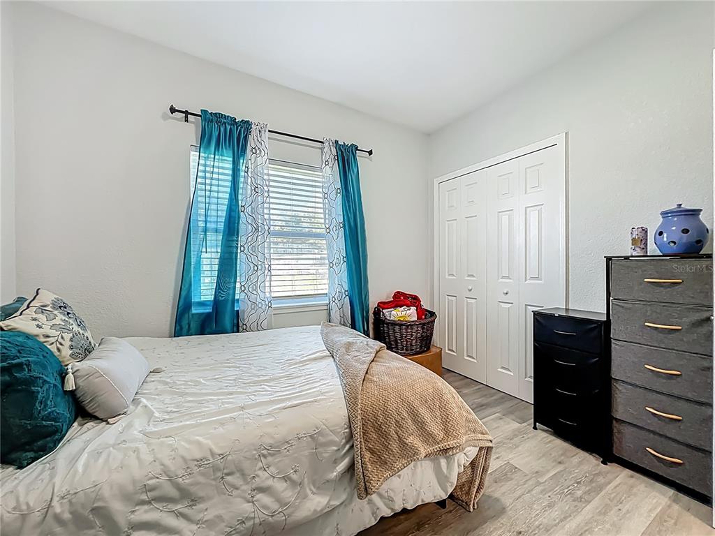 7033 Lakner Way Orlando, FL 32822 - Photo 23 of 31 a bedroom with a bed and a closet