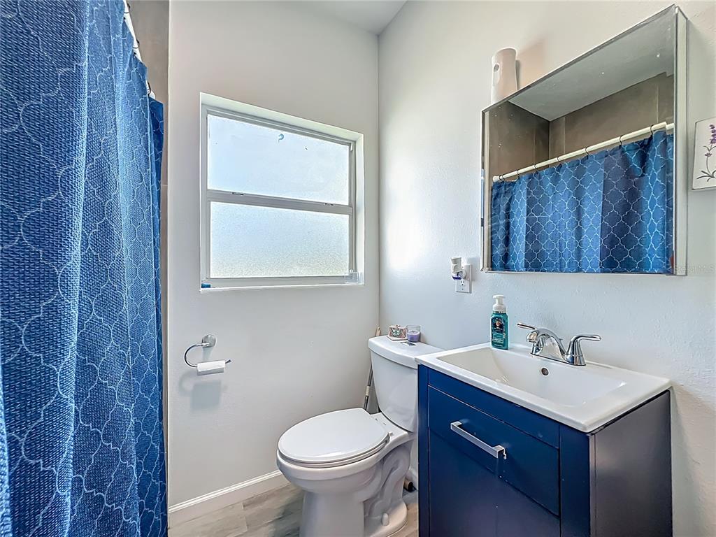 7033 Lakner Way Orlando, FL 32822 - Photo 26 of 31 a bathroom with a sink toilet and mirror