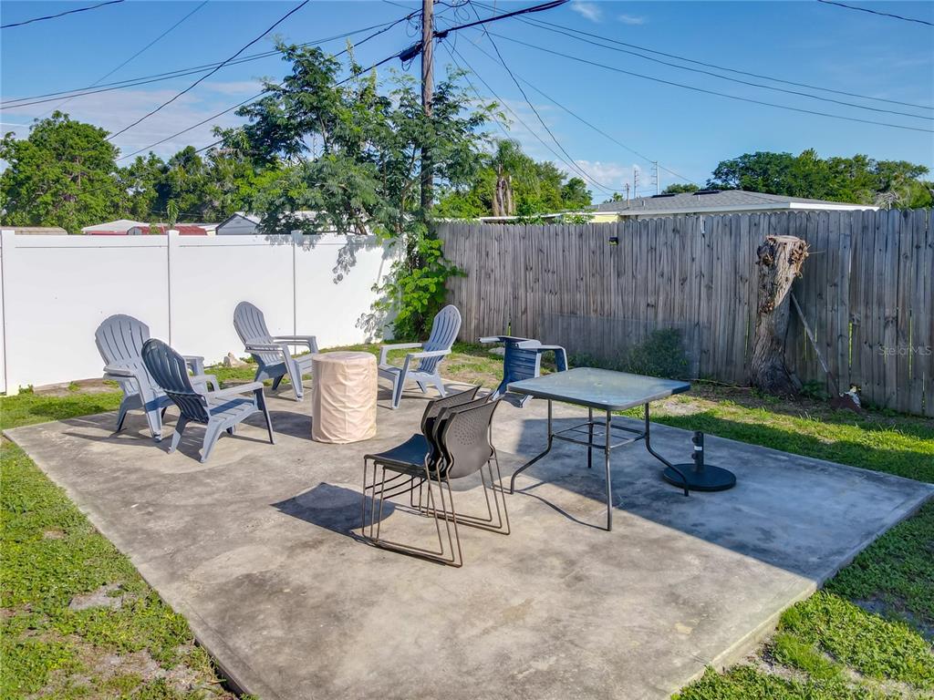 7033 Lakner Way Orlando, FL 32822 - Photo 28 of 31 a view of a backyard with chairs and a bench