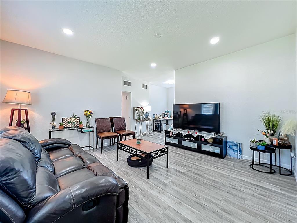 7033 Lakner Way Orlando, FL 32822 - Photo 5 of 31 a living room with furniture and a flat screen tv