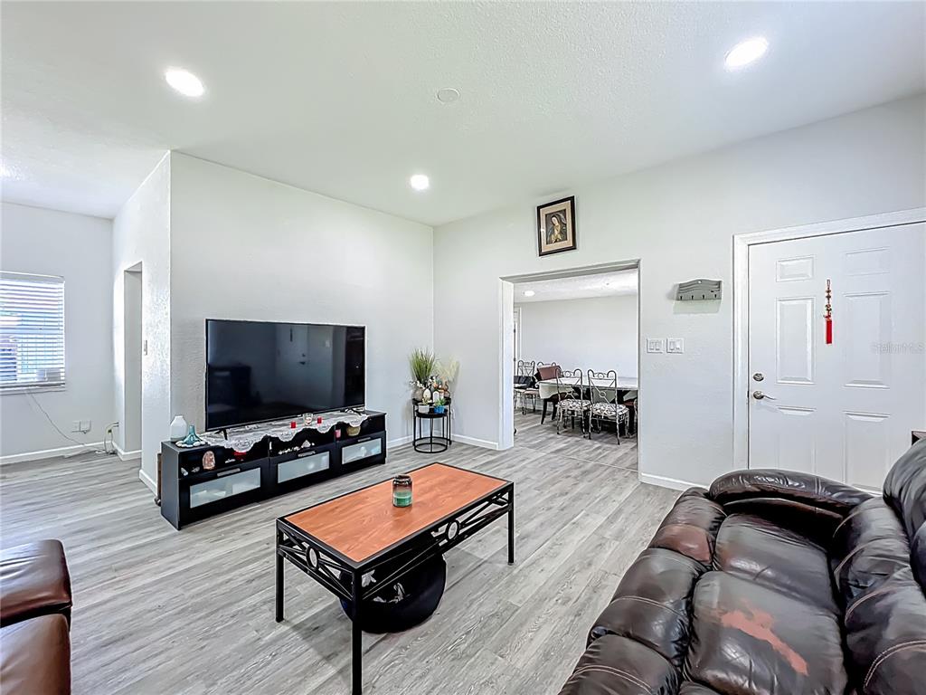 7033 Lakner Way Orlando, FL 32822 - Photo 6 of 31 a living room with furniture and a flat screen tv