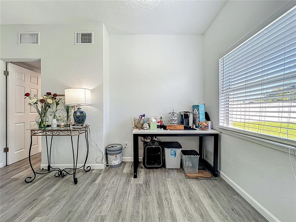 7033 Lakner Way Orlando, FL 32822 - Photo 9 of 31 a view of a workspace with furniture and a window