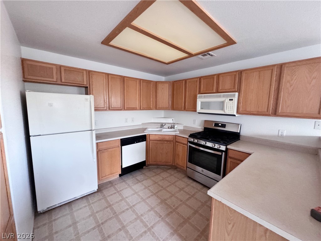 9580 West Reno Avenue, Unit 242 Las Vegas, NV 89148 - Photo 7 of 26 A well-appointed kitchen features ample cabinetry, appliances, and convenient counter space.