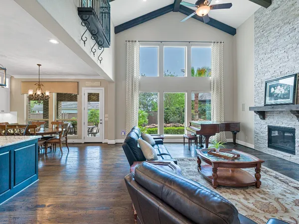 a living room with fireplace furniture and a large window