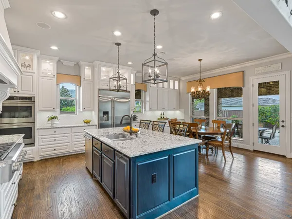 a kitchen with lots of counter top space and wooden floor