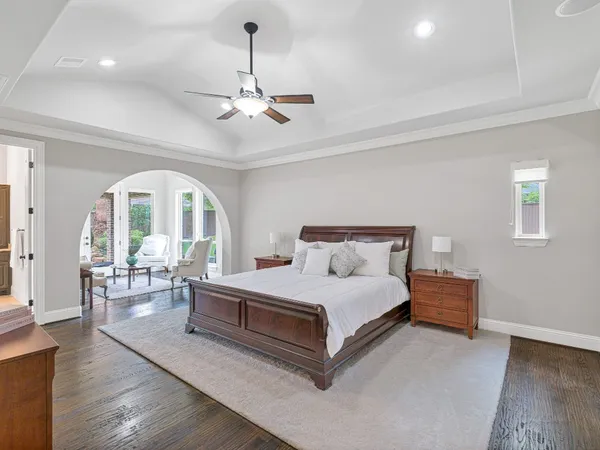 a bedroom with a bed and lamp on desk