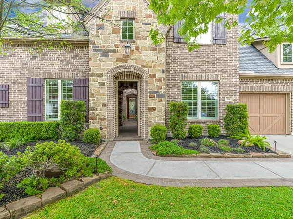 a front view of a house with a garden