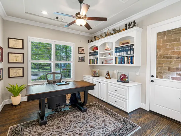 a room with gym equipment and wooden floor