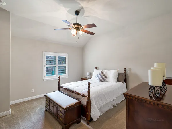 a bathroom with a granite countertop sink toilet a mirror and shower