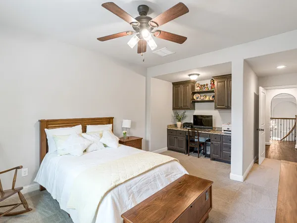 a bedroom with a large bed and a window