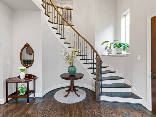 a view of entryway and hall with wooden floor