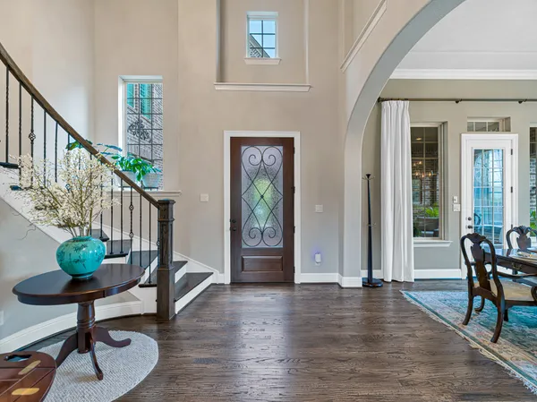 a view of an entryway with wooden floor and a livingroom